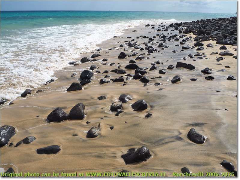 Black rocks, and yellow sahara sand.