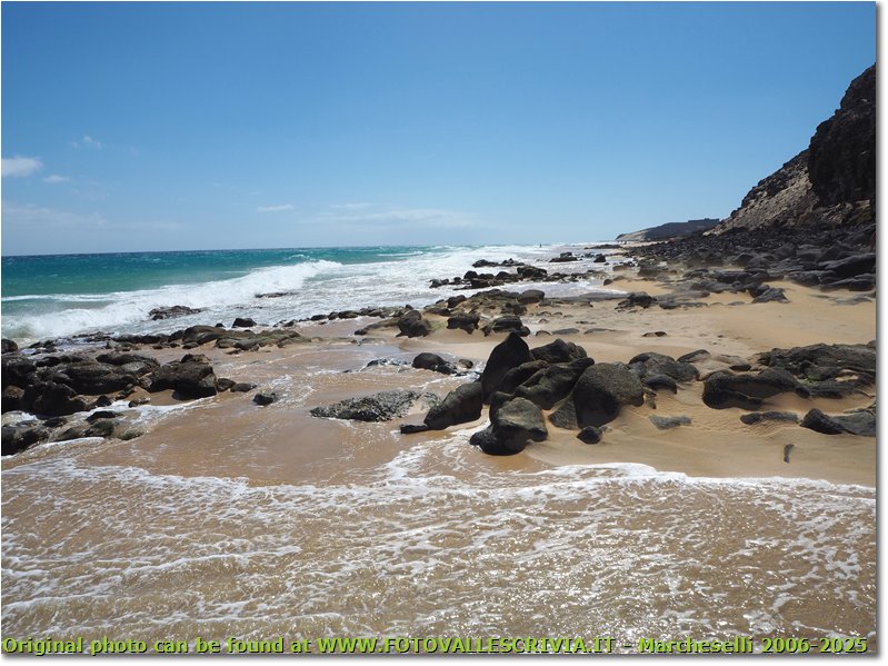 Rocks and sand at Sotavento beach south-west corner